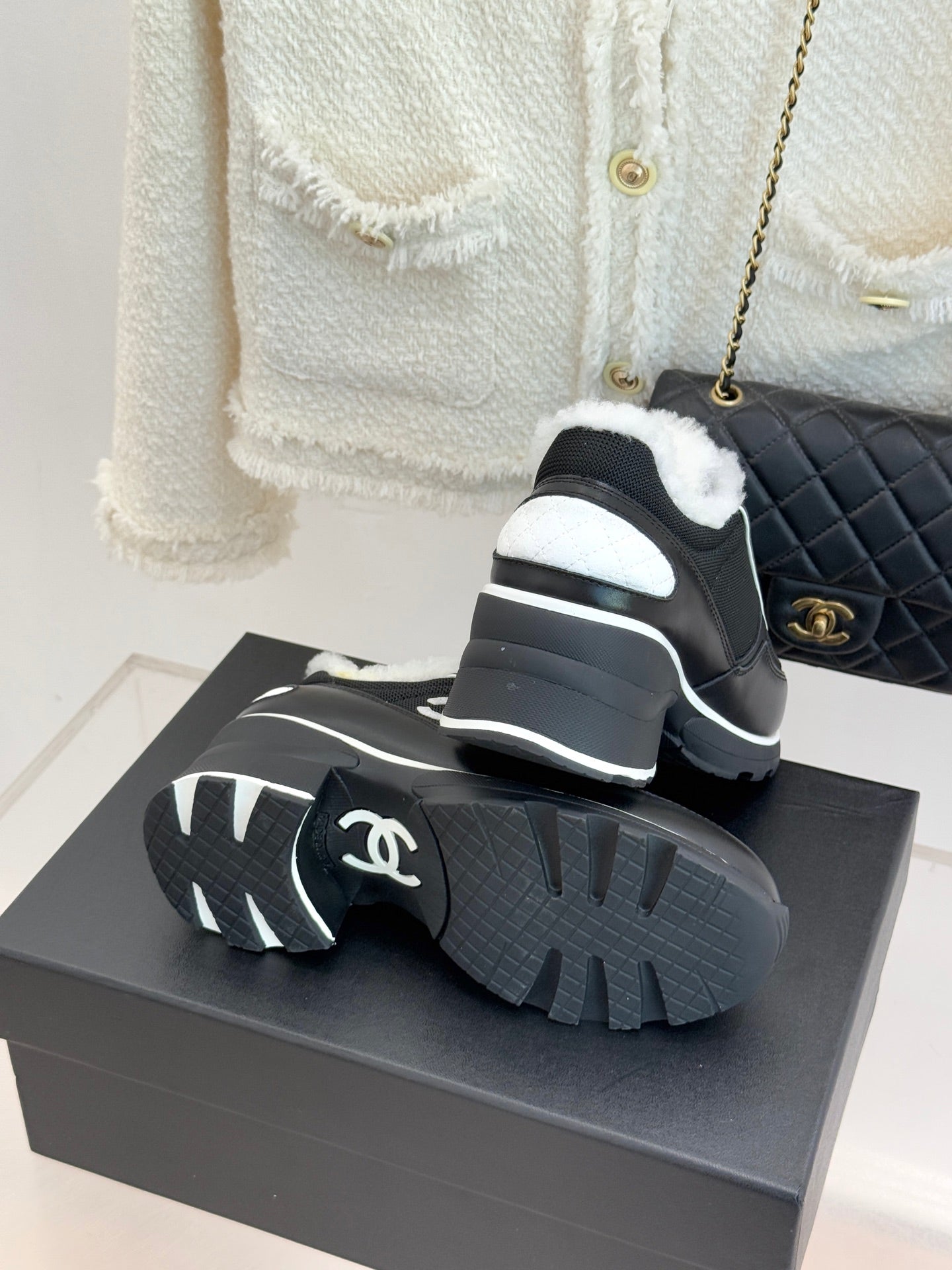 Chanel ladies sneakers showing tread, black outsole with white logo