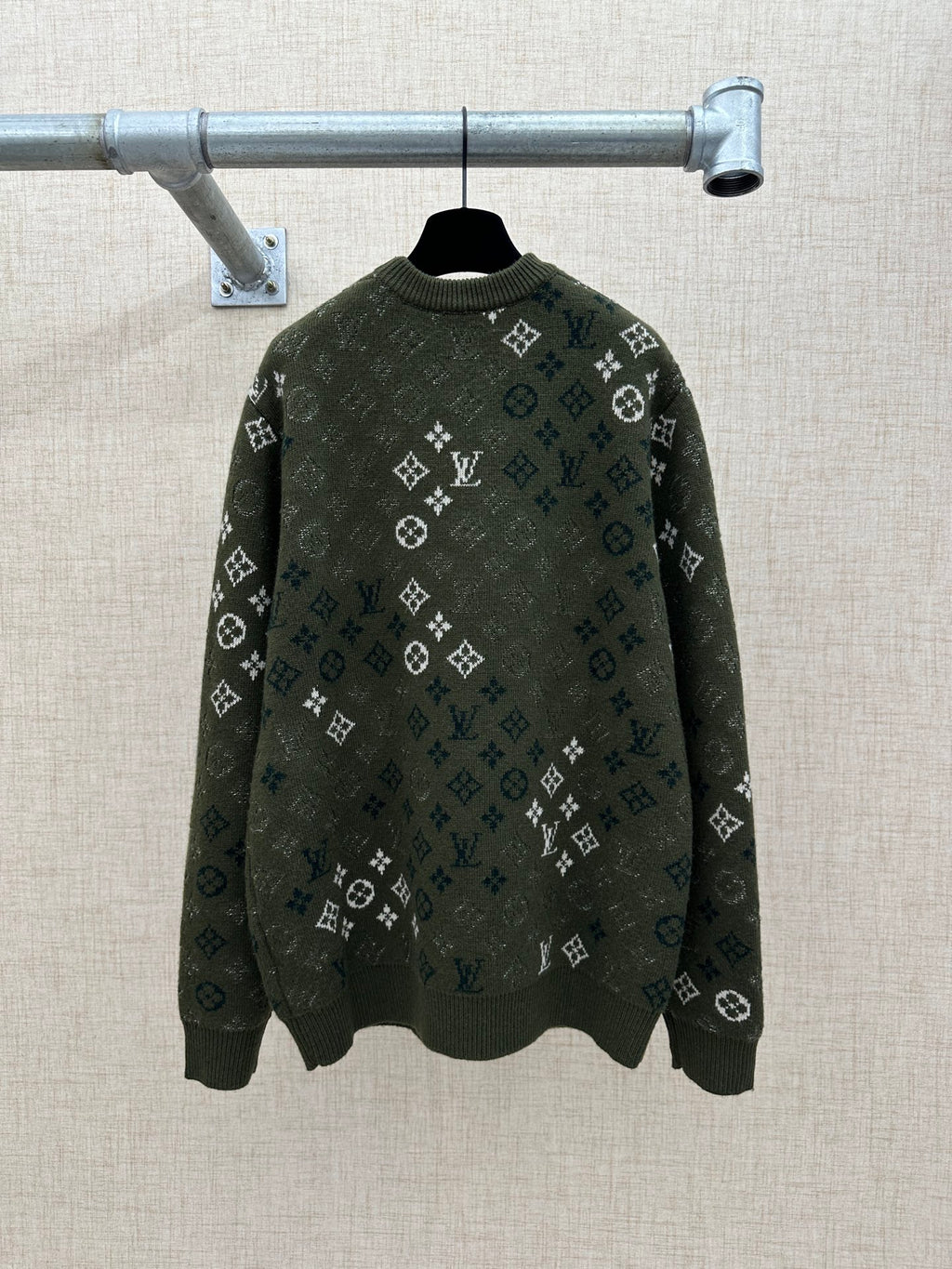 Dark green long-sleeve knit sweater with all-over logo pattern and ribbed crew neck