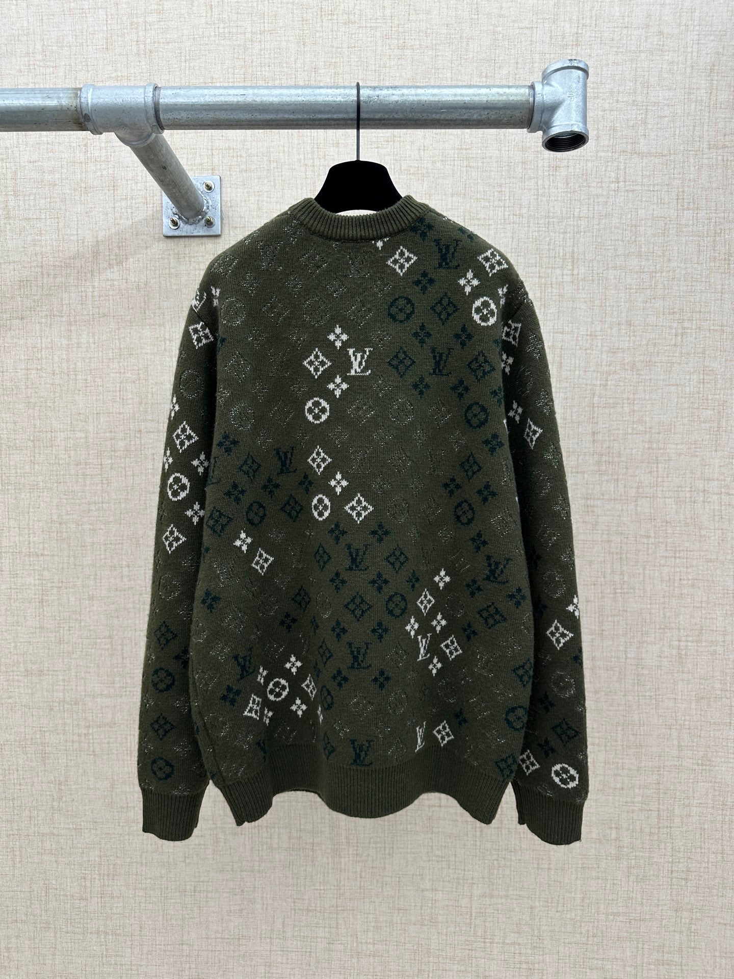 Dark green long-sleeve knit sweater with all-over logo pattern and ribbed crew neck