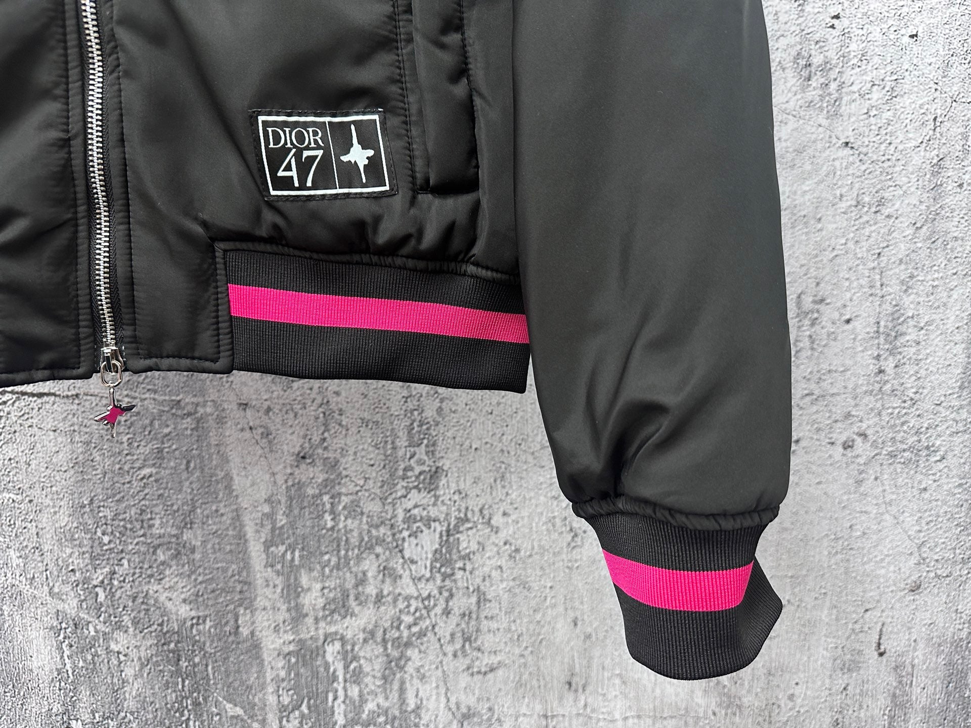Dior black bomber jacket cuff and hem with pink stripe and small Dior 47 label