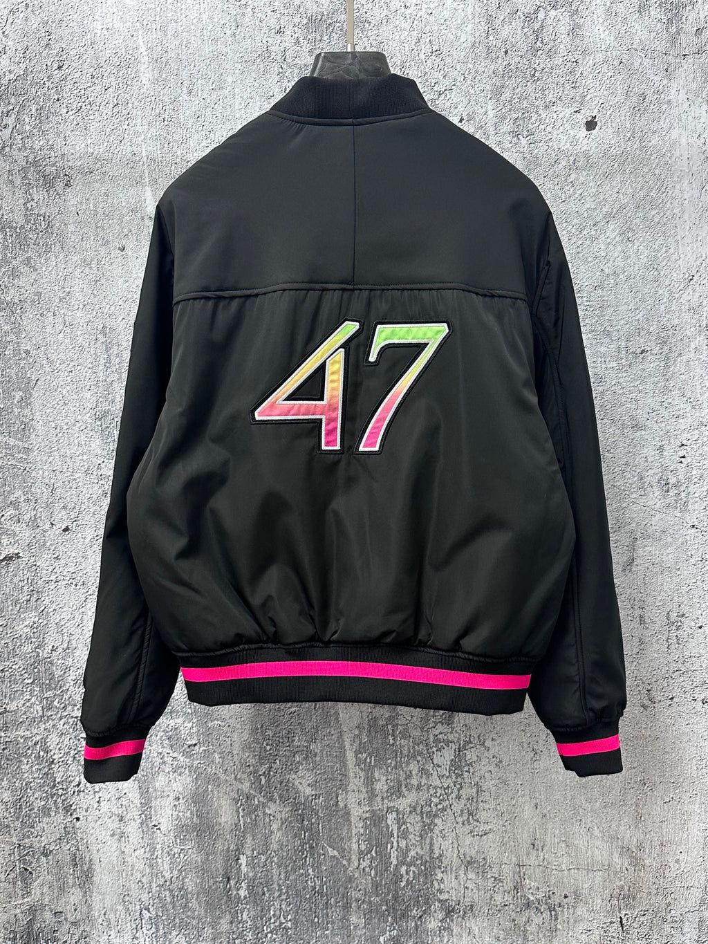 Dior black bomber jacket back with 47 graphic and pink-striped ribbed hem cuffs