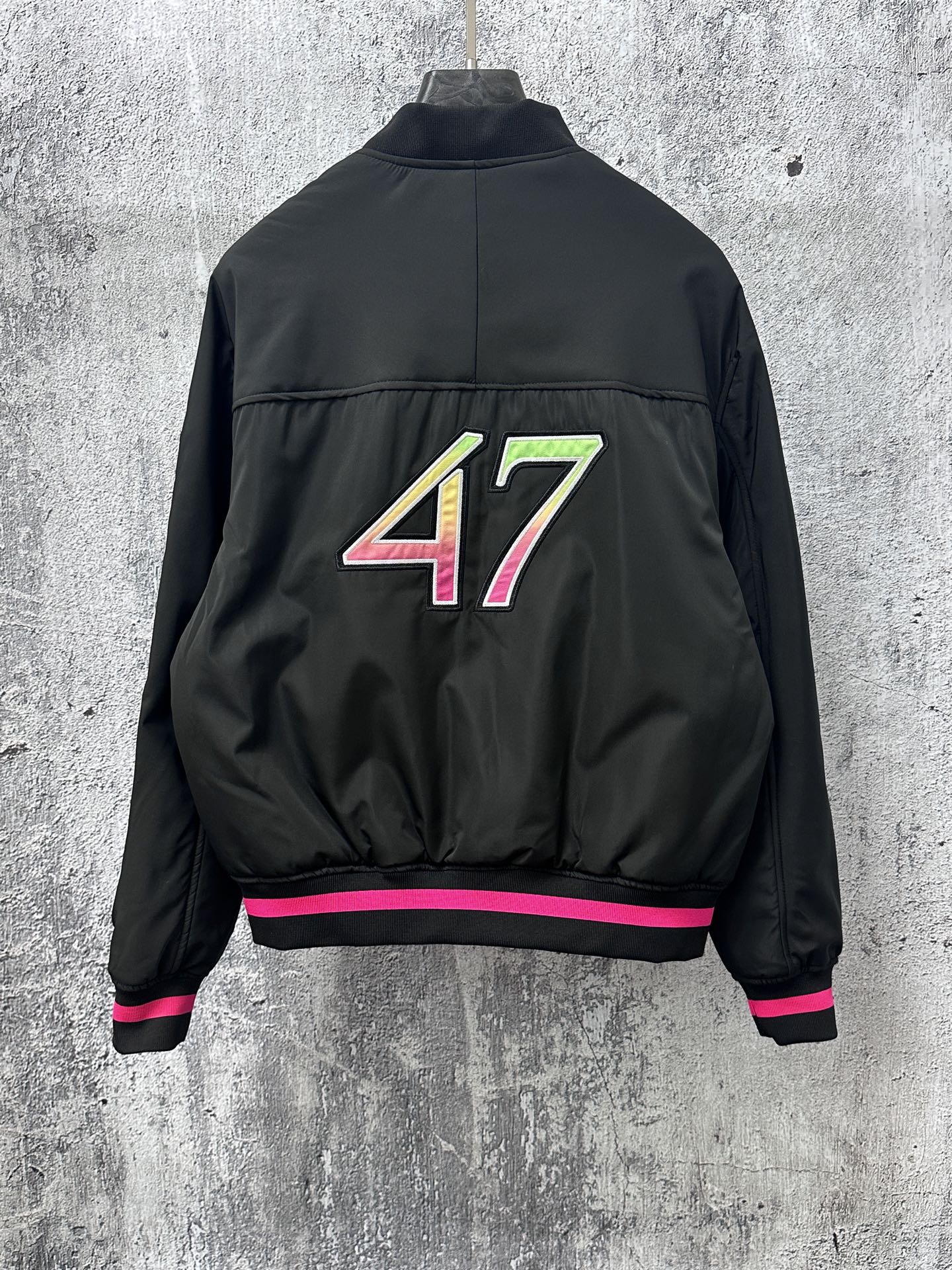 Dior black bomber jacket back with 47 graphic and pink-striped ribbed hem cuffs
