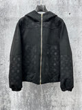 Dark hooded zip jacket with subtle monogram pattern and gold zipper hardware