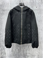 Dark hooded zip jacket with subtle monogram pattern and gold zipper hardware