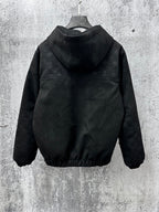 Dark hooded zip jacket with raised collar and full monogram pattern on sleeves