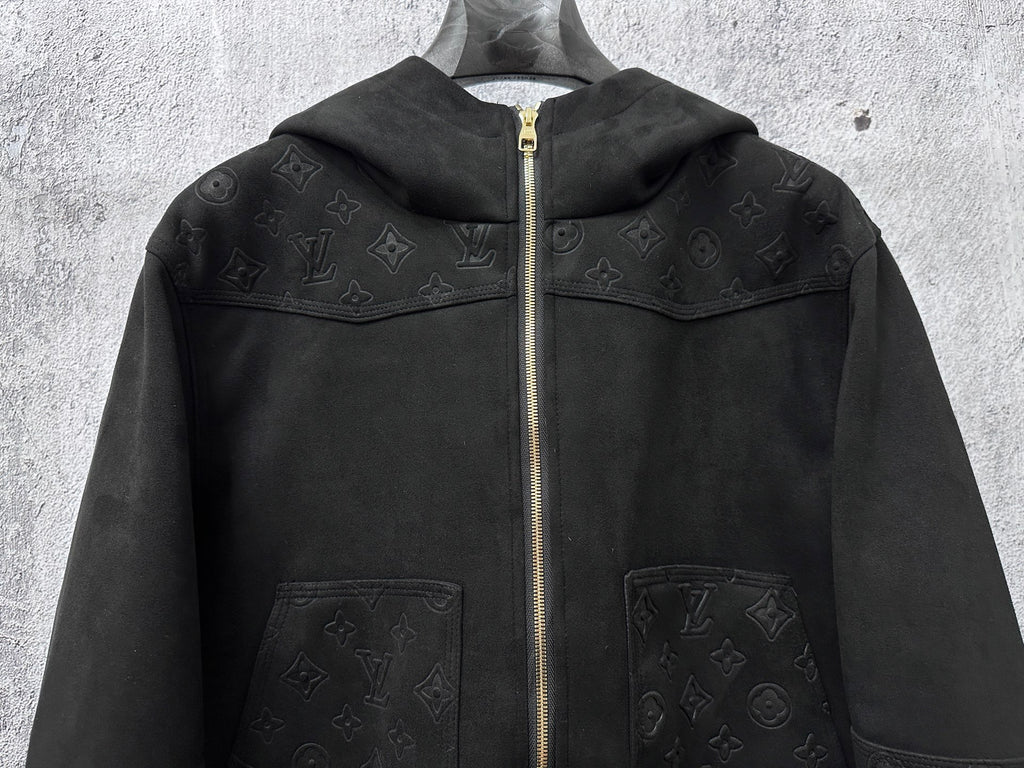 Dark hooded zip jacket front view with monogram panels and two chest pockets