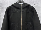 Dark hooded zip jacket front view with monogram panels and two chest pockets