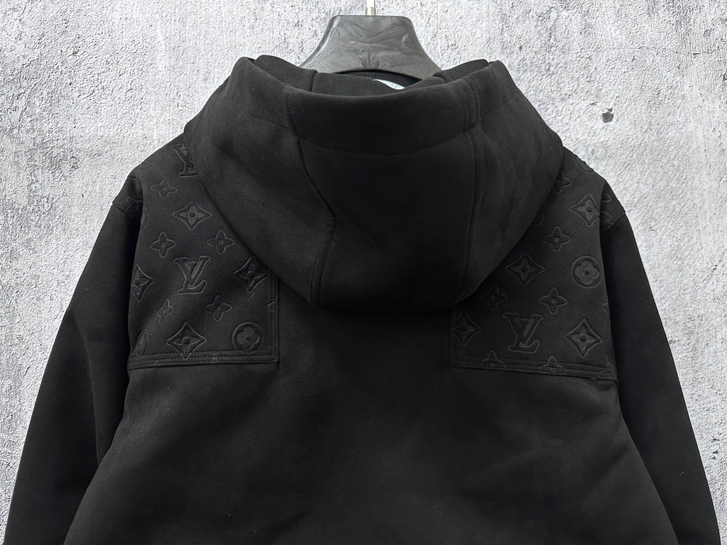 Dark hooded jacket back view with monogram shoulder panels and gathered hem