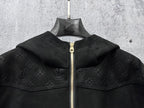 Dark hooded zip jacket close-up showing wide collar and gold zipper