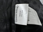 Clothing label inside dark leather jacket, shows size medium and fabric type.