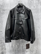 Dark leather jacket with spread collar, button front, and chest flap pockets.