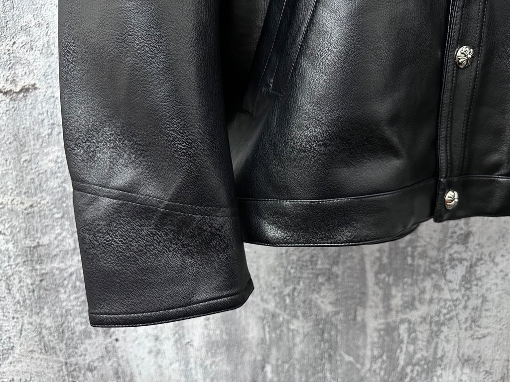 Dark leather jacket lower front with side seam paneling and buttoned detail.
