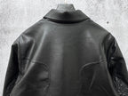 Dark leather jacket back view with high collar and curved seam panels.