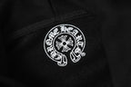 Black hoodie fabric close-up with small circular white logo