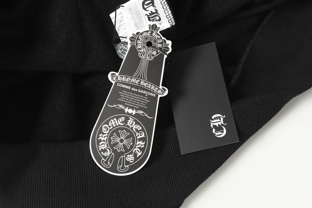 Black hoodie with hang tag and crest logo on fabric