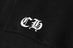 Black hoodie close-up with white monogram logo on fabric