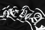 Black hoodie with large white graphic lettering