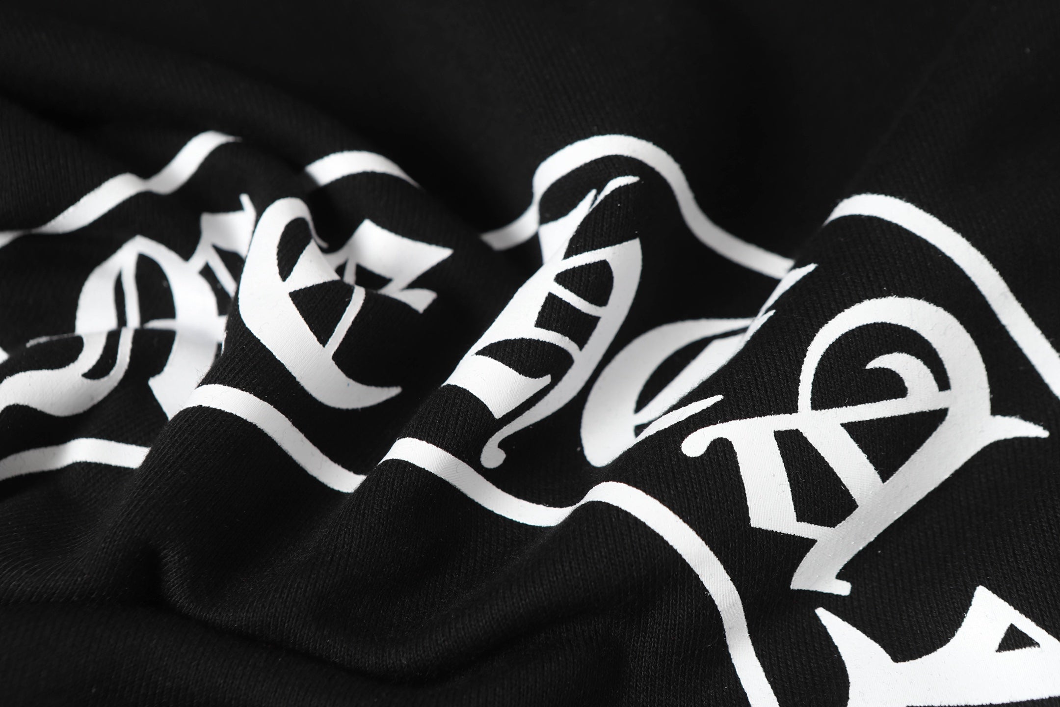 Black hoodie with large white graphic lettering