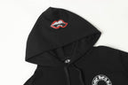 Black hoodie with drawstring hood and small red-and-white lip logo on upper back