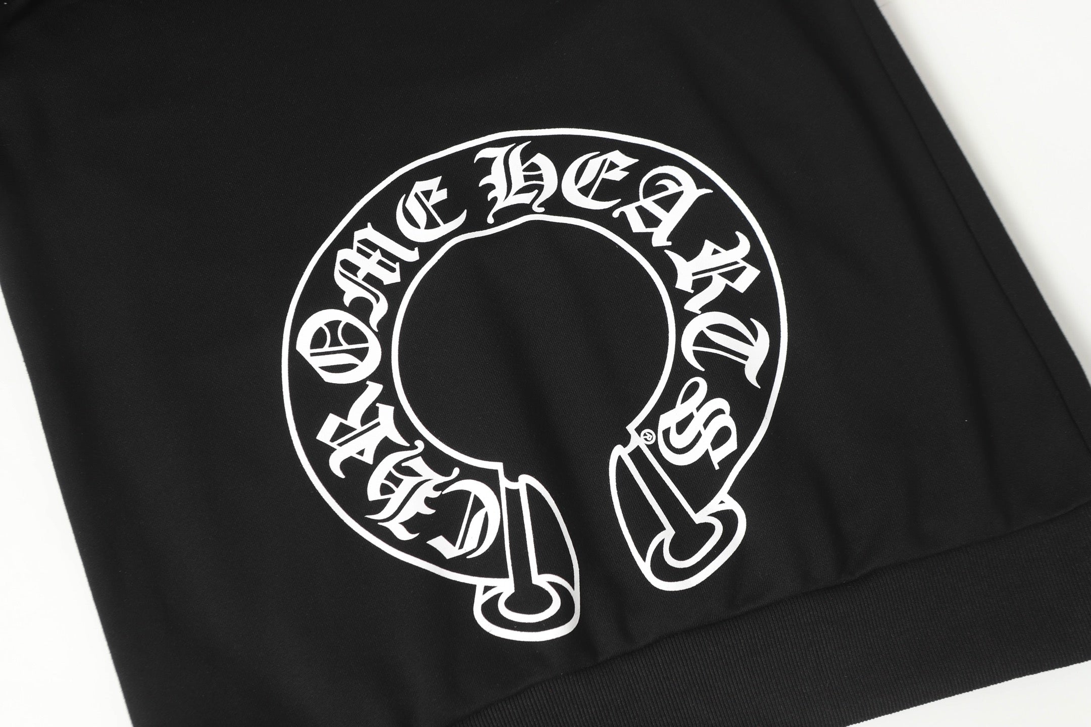 Black hoodie front panel with large circular white logo graphic