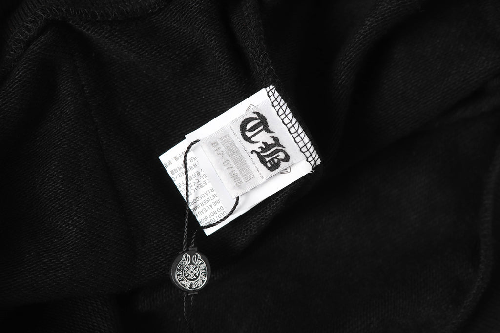Black hoodie fabric with neck tag and small logo charm