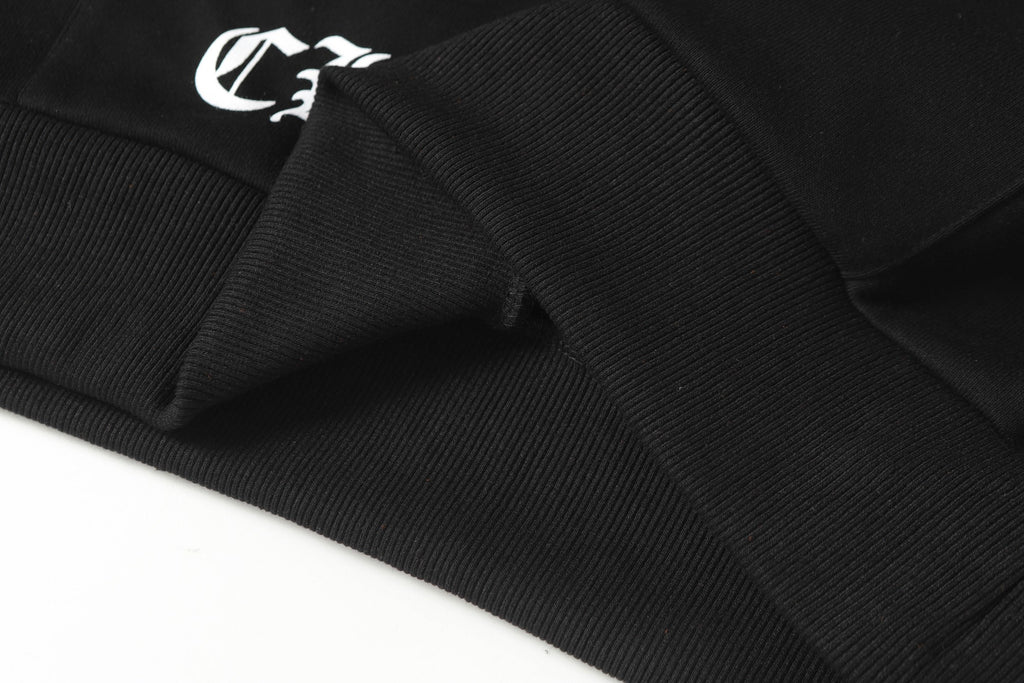 Black hoodie hem close-up with ribbed cuff and snap-button placket detail