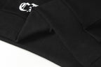 Black hoodie hem close-up with ribbed cuff and snap-button placket detail