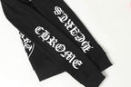 Black hoodie sleeve close-up with white stylized logo text