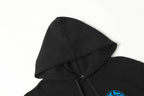 Black hoodie hood and neckline close-up with drawcords and partial blue emblem