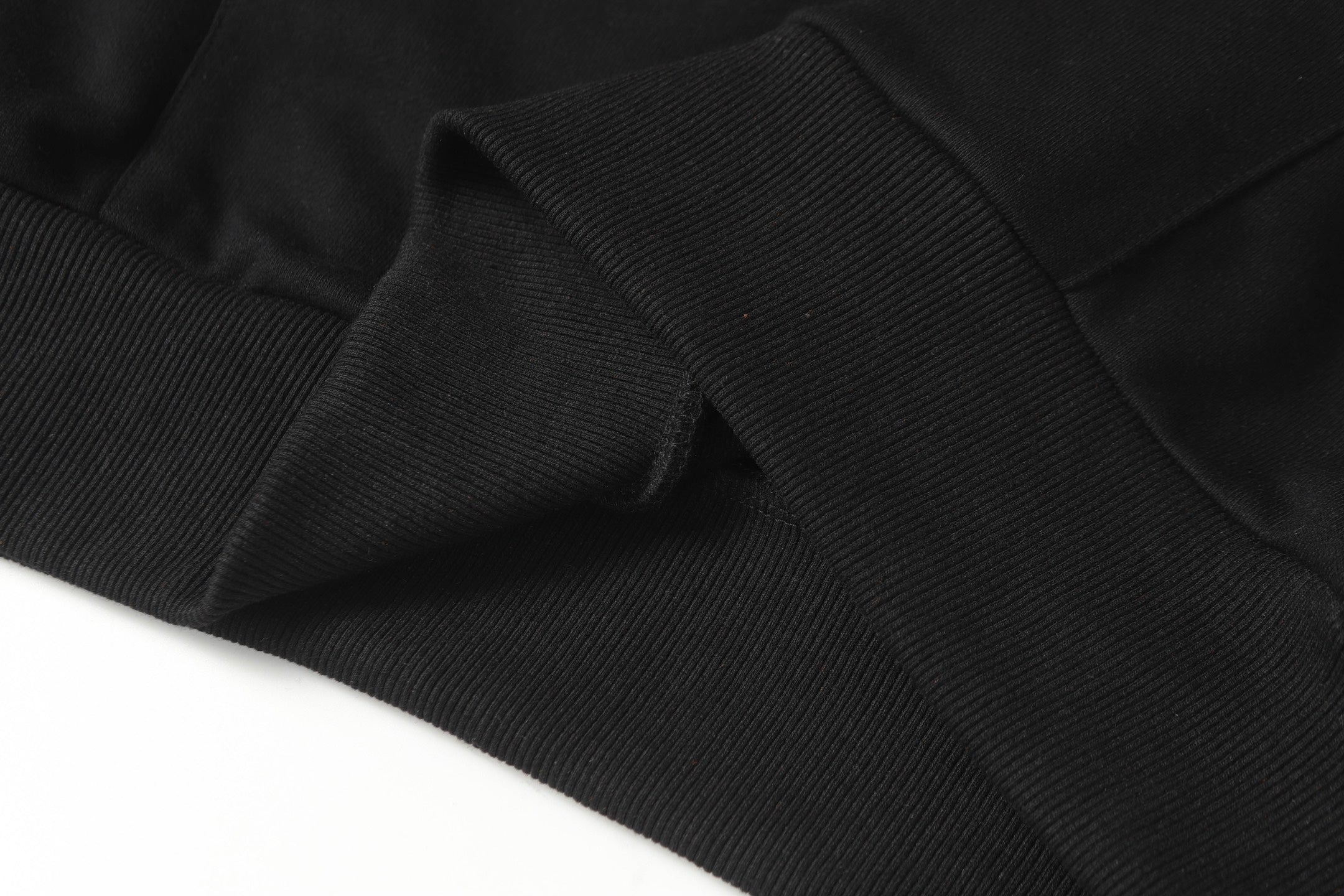 Black long-sleeve shirt fabric with ribbed knit cuffs