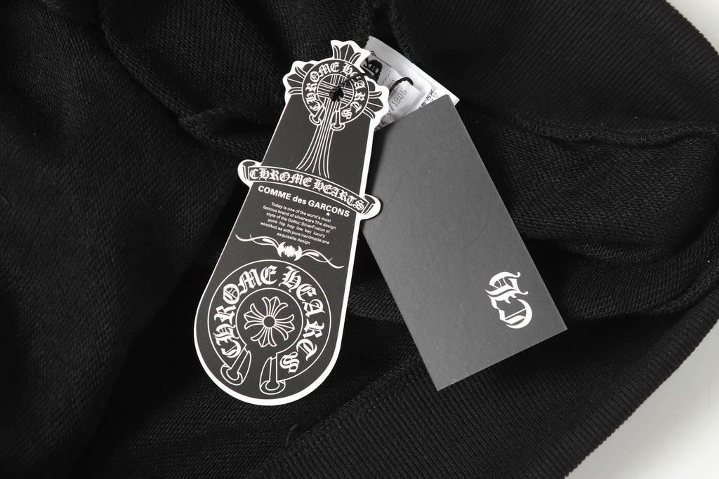 Black hoodie garment tags and neck label close-up on fabric