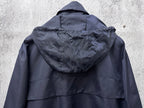 Long hooded jacket back view with adjustable hood and zipper seam, dark navy blue.