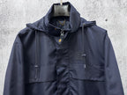 Long hooded jacket front view with drawstring hood and chest patch pockets, navy.