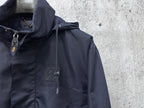 Hooded jacket close-up showing drawstring hood and zipper with dark navy fabric.