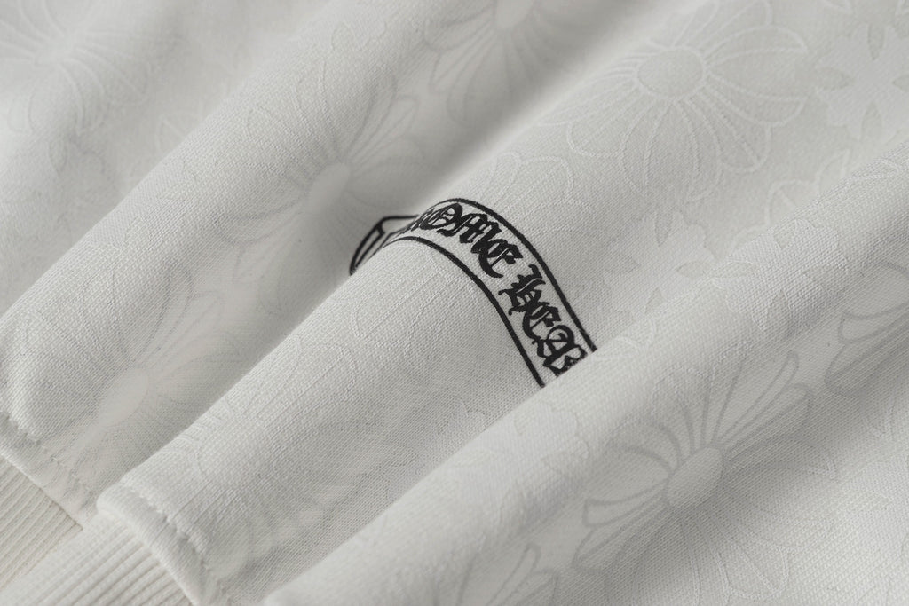 White zip-up hoodie sleeve with small embroidered crest label