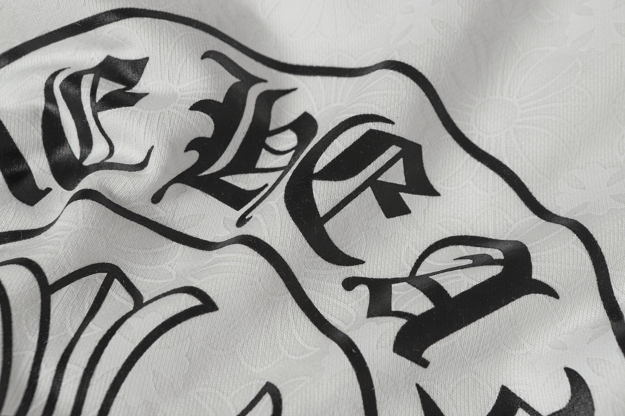 White zip-up hoodie fabric with large black gothic logo print