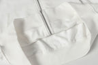 White zip-up hoodie with front zipper and stitched yoke panel