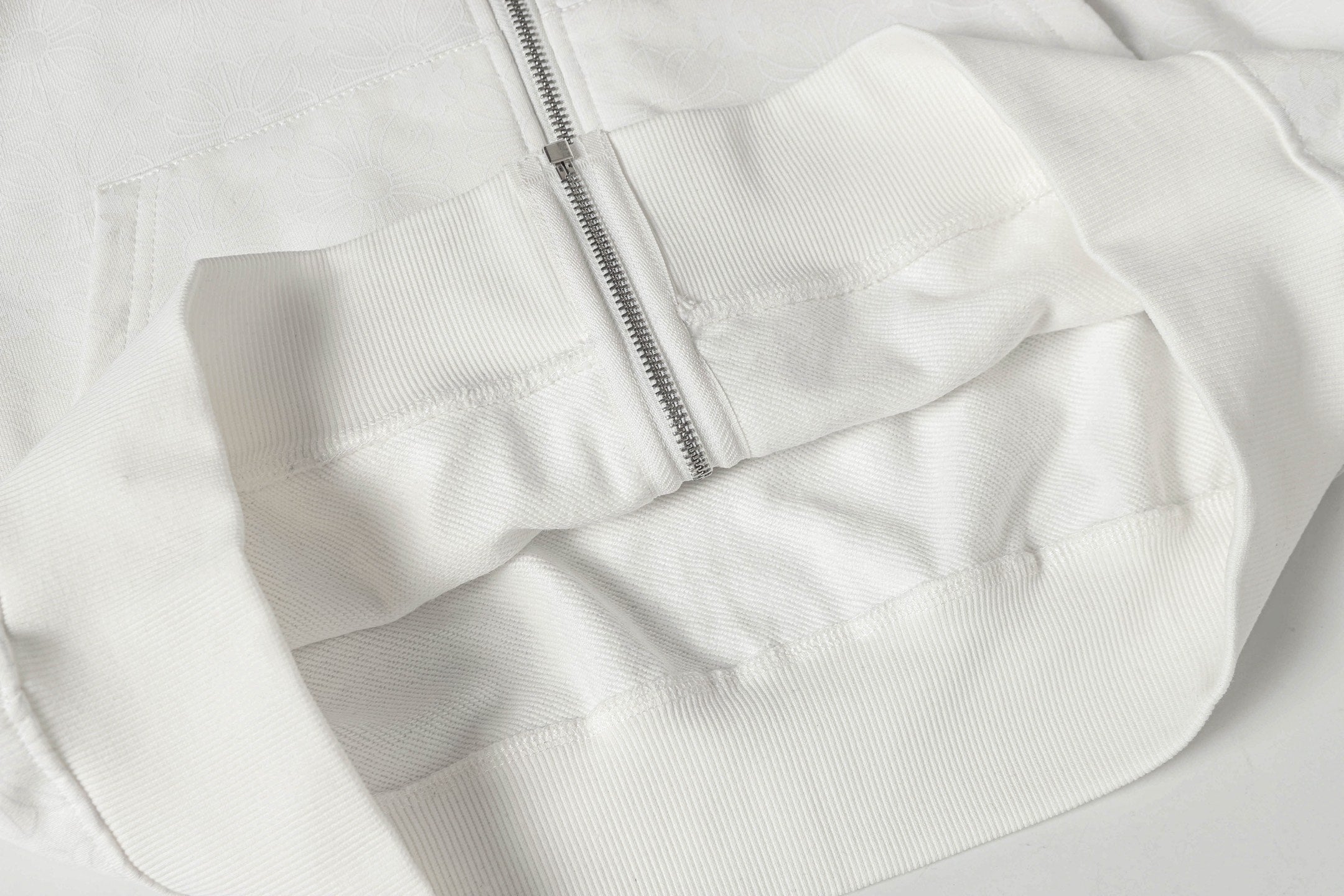 White zip-up hoodie with front zipper and stitched yoke panel