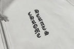 Chrome long hoodie chest emblem and patterned fabric texture close-up