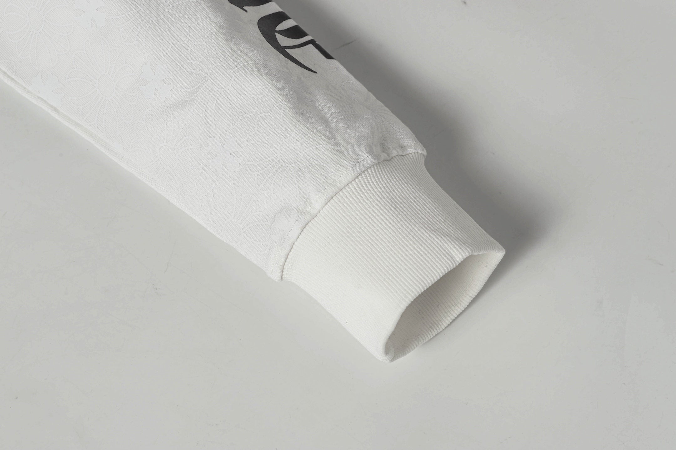White zip-up hoodie sleeve cuff with folded hem