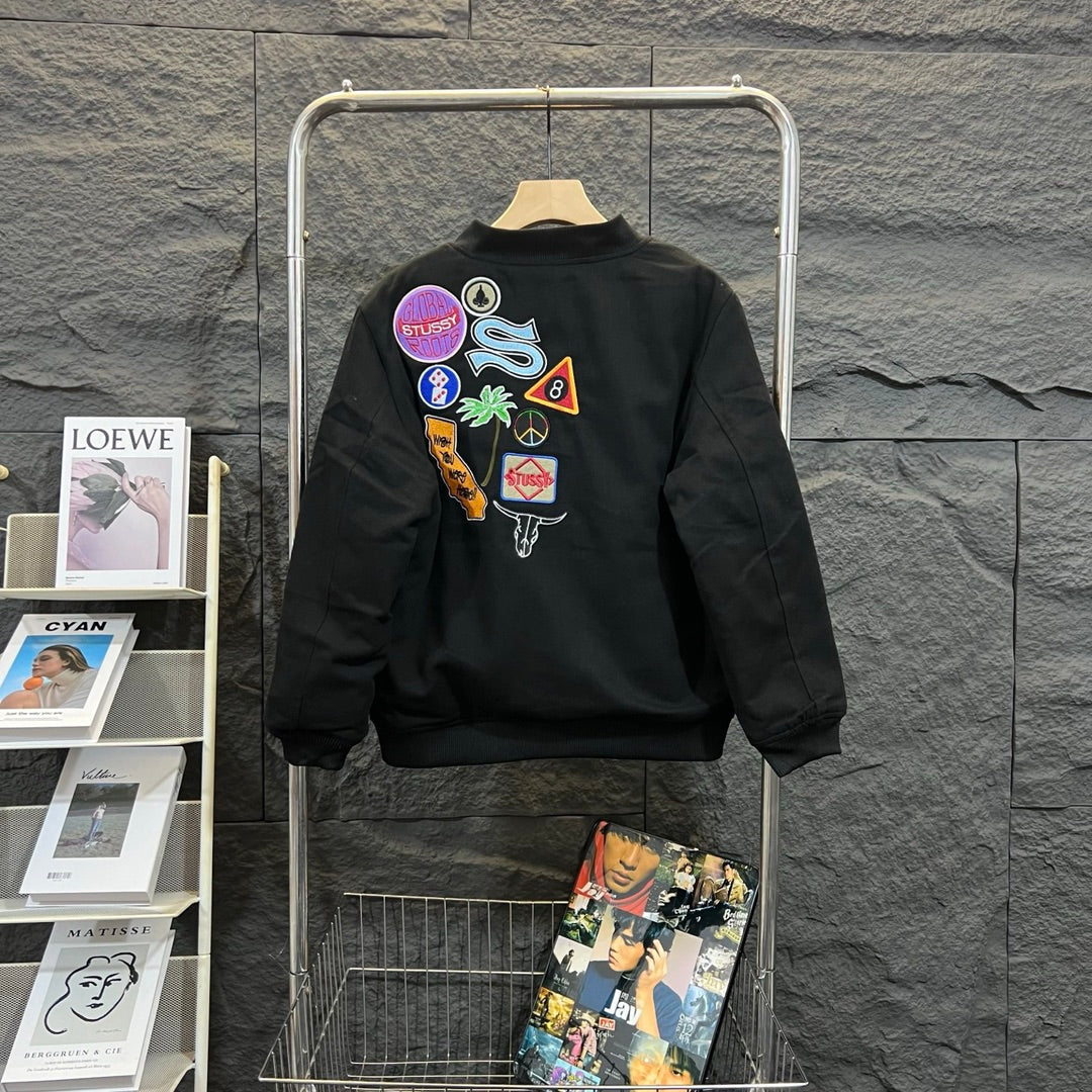 Stussy black bomber jacket, back graphic patches and ribbed hem cuffs