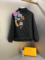 Black Stussy bomber jacket shown from back with large patch graphic