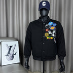 Black button-front bomber jacket on mannequin, colorful chest patches