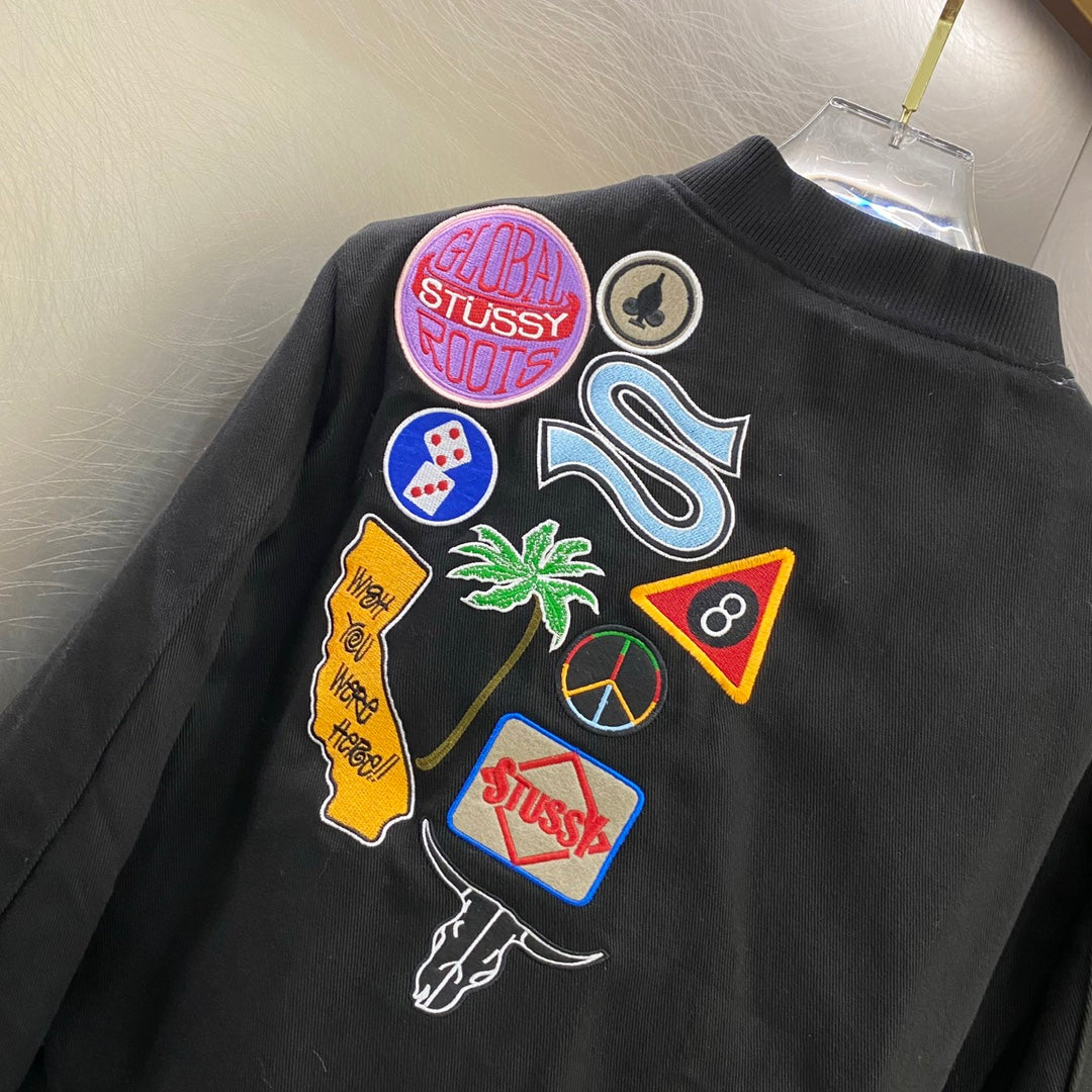 Black jacket back with colorful stitched patches and logo emblems
