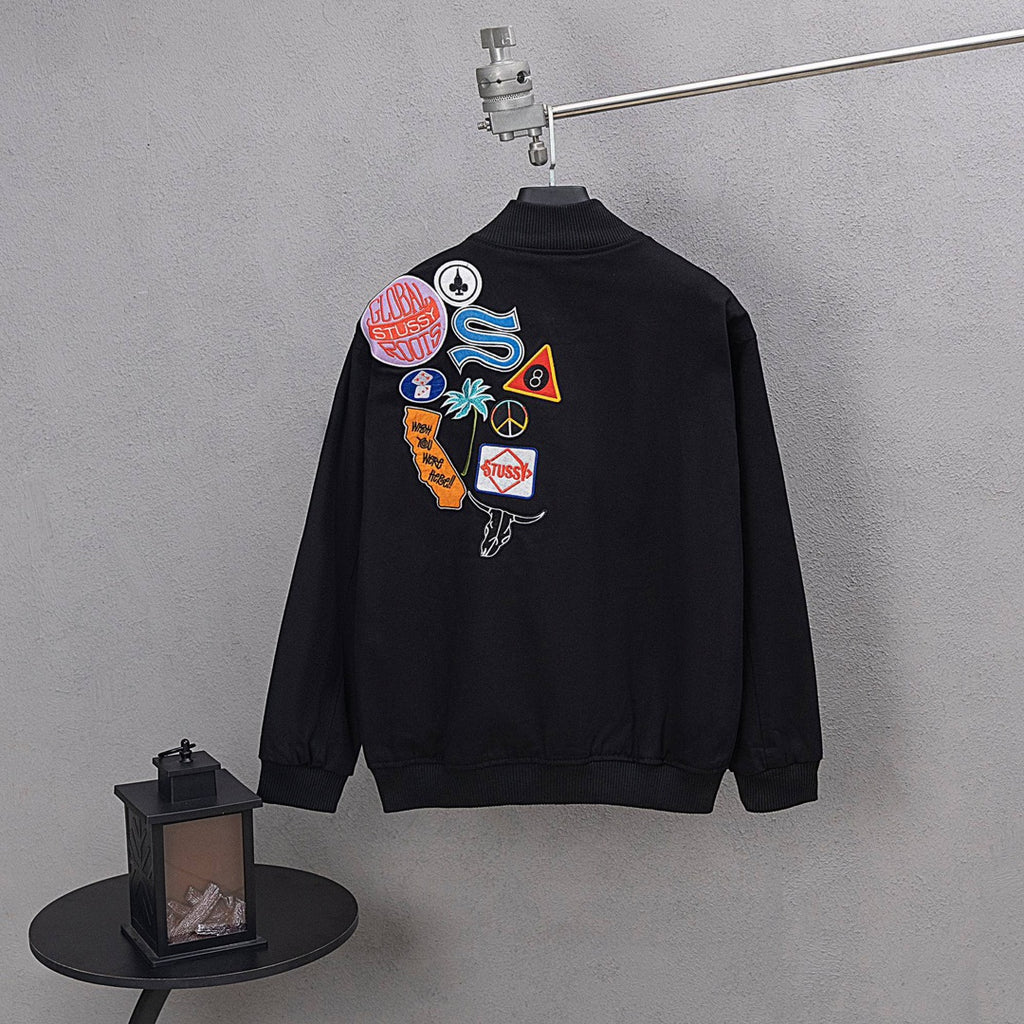 Stussy black bomber jacket, back graphic patch cluster and ribbed cuffs
