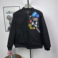 Black Stussy button-front bomber jacket with colorful chest patch graphic