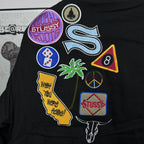 Black Stussy bomber jacket back with multicolor symbol patches