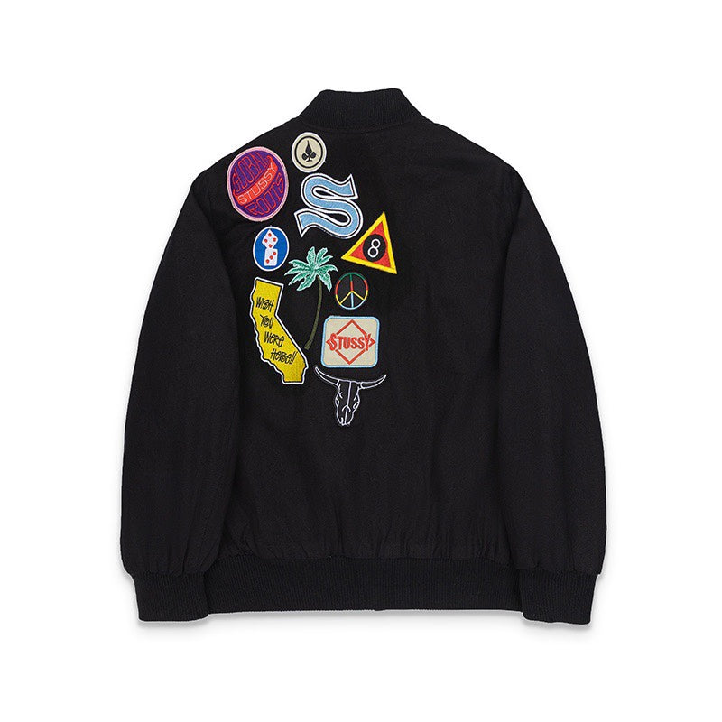 Black jacket back with colorful stitched patches and logo emblems