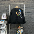 Stussy black bomber jacket, front with colorful patch collage and button placket