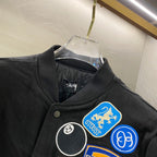 Black snap-front jacket collar with round and graphic patches